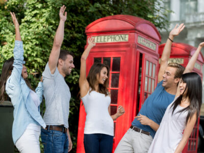 Group of exchange students in London giving a high-five - teamwork concepts